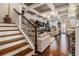 Bright living room with hardwood floors, coffered ceilings and elegant staircase at 2404 Fitts Dr, Conyers, GA 30094