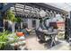 Outdoor patio with a dark pergola that's decorated with lights and lush foliage at 2404 Fitts Dr, Conyers, GA 30094