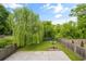 Spacious backyard with mature trees, landscaping, concrete patio, and a charming fire pit area at 925 Hill Se St, Atlanta, GA 30315