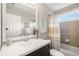 Bathroom featuring a vanity with large mirror, tiled shower and tub combination, and neutral finishes at 925 Hill Se St, Atlanta, GA 30315