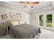 Inviting bedroom with a tray ceiling and private door leading to a deck or patio at 925 Hill Se St, Atlanta, GA 30315