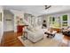 Spacious living room with hardwood floors, cozy sectional, and staircase at 925 Hill Se St, Atlanta, GA 30315