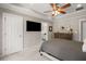 Main bedroom with tray ceilings, a large TV, and attached en-suite bathroom at 925 Hill Se St, Atlanta, GA 30315