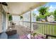 Covered porch with comfortable seating and hanging plants overlooking the landscaped front yard at 925 Hill Se St, Atlanta, GA 30315