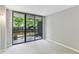This bedroom features sliding glass doors that lead to a private balcony and views of lush trees at 1130 Piedmont Ne Ave # 410, Atlanta, GA 30309