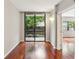Open and bright living room with wood floors and sliding glass doors to the balcony with tree views at 1130 Piedmont Ne Ave # 410, Atlanta, GA 30309
