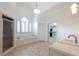 Bright bathroom featuring a soaking tub, walk-in shower, and access to a large walk-in closet at 185 Windsor Cv, Sandy Springs, GA 30328