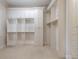 Walk-in closet complete with custom built-in shelving, drawers, and ample storage space at 185 Windsor Cv, Sandy Springs, GA 30328