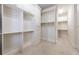 Large walk-in closet featuring custom storage solutions, built-in shelving, and drawers at 185 Windsor Cv, Sandy Springs, GA 30328