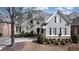 Inviting two-story home features a combination of stone and siding, creating a classic and elegant facade at 185 Windsor Cv, Sandy Springs, GA 30328