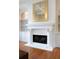 Close-up of a beautifully detailed white fireplace with a decorative mantel and built-in shelving at 185 Windsor Cv, Sandy Springs, GA 30328