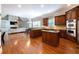 Open kitchen and living room featuring custom wood cabinets and stainless appliances at 185 Windsor Cv, Sandy Springs, GA 30328