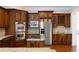Kitchen featuring stainless appliances, custom wood cabinets, and wine storage at 185 Windsor Cv, Sandy Springs, GA 30328
