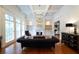 Elegant living room featuring hardwood floors, coffered ceiling, fireplace, and built-in bookshelves at 185 Windsor Cv, Sandy Springs, GA 30328