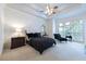 Spacious main bedroom featuring tray ceilings, large window and sitting area at 185 Windsor Cv, Sandy Springs, GA 30328