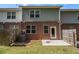 Backyard view with brick exterior, small patio, fenced in area, and window views to home interior at 1881 Millstream Holw, Conyers, GA 30012