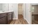 Bathroom with dark wood cabinets, modern sink, and view to a walk-in closet at 1881 Millstream Holw, Conyers, GA 30012
