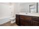 Full bathroom with white tile shower/tub combo and dark wood vanity with a white countertop at 1881 Millstream Holw, Conyers, GA 30012