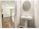 Elegant half bath with a pedestal sink and stylish mirror at 1881 Millstream Holw, Conyers, GA 30012