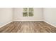 Bright bedroom with a large window and hardwood flooring at 1881 Millstream Holw, Conyers, GA 30012