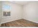 Empty bedroom with hardwood flooring, neutral walls, and a window overlooking the neighborhood at 1881 Millstream Holw, Conyers, GA 30012