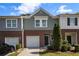 Charming townhome featuring a brick facade, attached garage, and manicured landscaping at 1881 Millstream Holw, Conyers, GA 30012