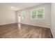 Spacious living room with hardwood floors, natural light, and access to the backyard at 1881 Millstream Holw, Conyers, GA 30012