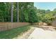 Expansive backyard featuring a wooden fence, mature trees, and a well-maintained lawn at 2889 Estuary Dr, Acworth, GA 30101