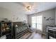 Adorable Bedroom with dinosaur decor, a gray crib, and a ceiling fan at 2889 Estuary Dr, Acworth, GA 30101