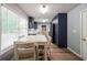 Bright dining area showcases a farm table, stylish navy cabinets, hardwood floors, and tons of natural light at 2889 Estuary Dr, Acworth, GA 30101