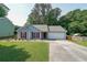 Traditional home boasts a manicured lawn, long driveway, attached garage and charming red shutters, creating a welcoming curb appeal at 2889 Estuary Dr, Acworth, GA 30101
