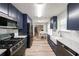 Stylish kitchen features navy cabinets, white subway tile backsplash, stainless steel appliances, and wood floors at 2889 Estuary Dr, Acworth, GA 30101