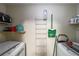 Functional laundry area featuring white machines, a storage rack, and convenient shelving at 2889 Estuary Dr, Acworth, GA 30101