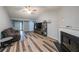 Cozy living room featuring a fireplace, light grey walls, hardwood floors, and lots of natural light at 2889 Estuary Dr, Acworth, GA 30101