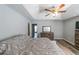 Spacious main bedroom featuring tray ceilings, ceiling fan and a wooden dresser at 2889 Estuary Dr, Acworth, GA 30101
