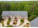 Aerial view of luxury townhomes surrounded by lush green trees and manicured lawns at 320 Wisteria Cir, Roswell, GA 30076