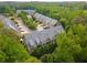 Aerial view of townhomes nestled among lush trees in a serene neighborhood setting at 320 Wisteria Cir, Roswell, GA 30076