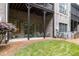 Spacious brick back porch with covered area and grassy yard, perfect for outdoor enjoyment at 320 Wisteria Cir, Roswell, GA 30076
