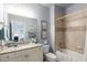Bathroom with tiled shower-tub, granite counters, and white cabinets at 320 Wisteria Cir, Roswell, GA 30076