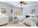 Light-filled bedroom features two twin beds, light blue walls, and white shutters at 320 Wisteria Cir, Roswell, GA 30076