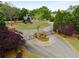 Gated community entrance with manicured landscaping and mature trees at 320 Wisteria Cir, Roswell, GA 30076