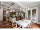 Bright eat-in kitchen and dining area with chandelier lighting, open to the patio at 320 Wisteria Cir, Roswell, GA 30076