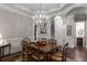 Elegant dining room with hardwood floors, chandelier, and access to other living spaces at 320 Wisteria Cir, Roswell, GA 30076