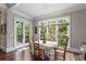 Bright dining room features beautiful hardwood floors, large windows, and access to the outdoor balcony at 320 Wisteria Cir, Roswell, GA 30076