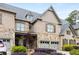 Beautiful townhome featuring a stone and brick facade, two-car garage, and inviting curb appeal at 320 Wisteria Cir, Roswell, GA 30076