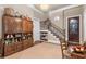 Inviting foyer featuring decorative staircase, hardwood door, and built-in cabinet at 320 Wisteria Cir, Roswell, GA 30076