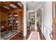 Elegant foyer with hardwood floors, decorative columns, and an office with built-in shelves at 320 Wisteria Cir, Roswell, GA 30076