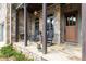 Inviting front porch with stone columns, rocking chairs, and a beautiful stone floor at 320 Wisteria Cir, Roswell, GA 30076