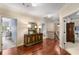 Hallway with hardwood floors and decorative console offers access to multiple rooms at 320 Wisteria Cir, Roswell, GA 30076