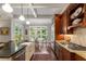 Well-appointed kitchen with stainless appliances, island with seating, and backyard views at 320 Wisteria Cir, Roswell, GA 30076